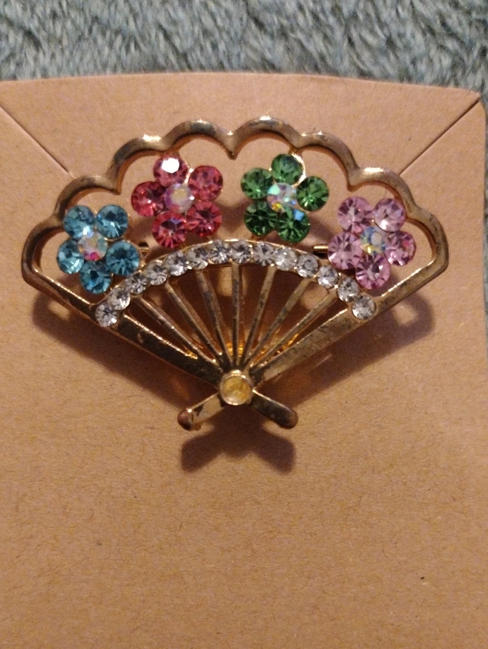 Vintage rhinestones fan brooch 2"w x 1"h.